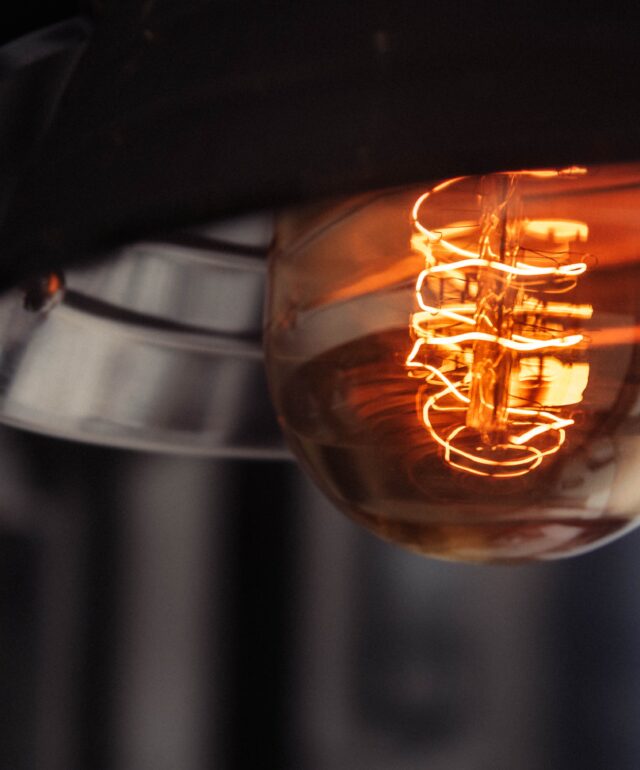 Closeup shot of a lit large lightbulb with a blurred background Closeup shot of a lit large lightbulb with a blurred background
